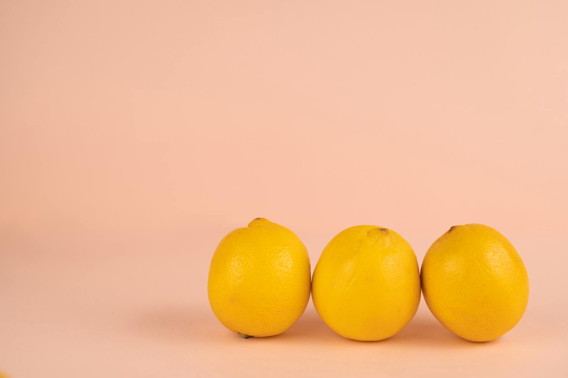 Bright ripe lemons arranged on a pastel background, representing renewal and vitality